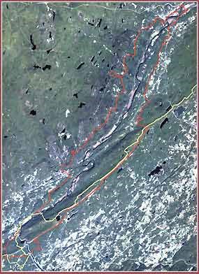 Satellite image of a river valley. Boundaries are overlaid on the image in red and yellow.