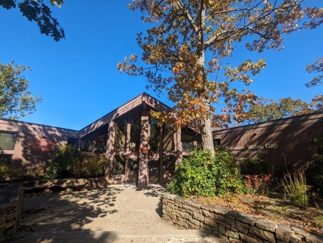 A brown, craftsman style building with large windows.