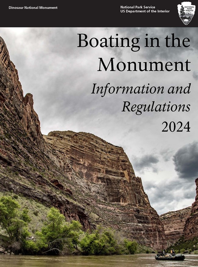 Two people in a raft float down a river surrounded by steep canyon walls. Overlying text reads "Boating in the Monument Information and Regulations 2024."