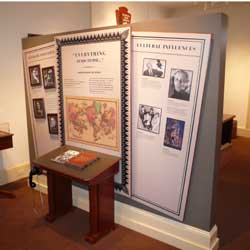 Photo of 3 panels and desk highlighting Poe's influence on today's literary and culture
