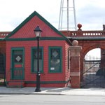 A red gatehouse with green trim at the corner of Thomas Edison NHP