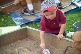 Kids Archeology Day 2005 Child in mock dig sandbox