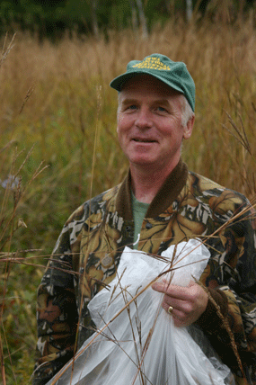 Volunteer collecting prairie seed