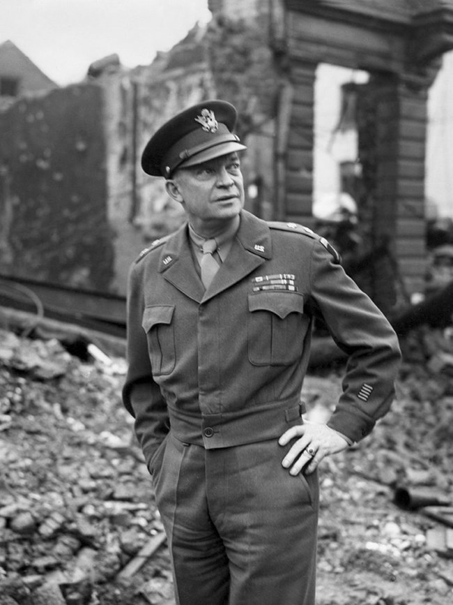 A black and white image of General Dwight Eisenhower in Bastogne in February 1945