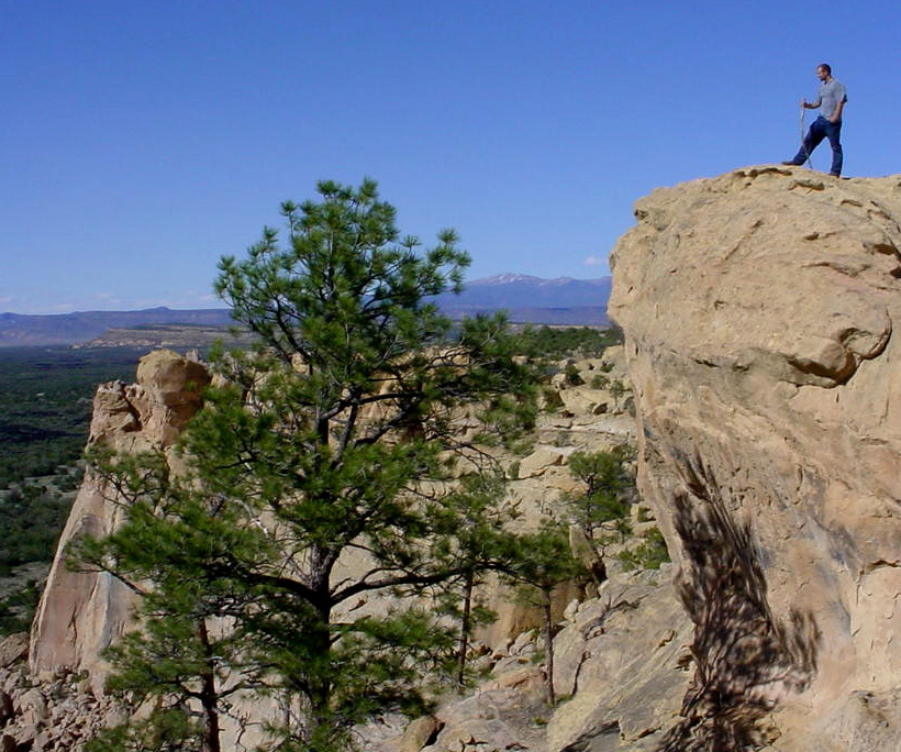 A hiker surveys the landscape at Sandstone Bluffs.
