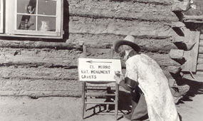 Image of a woman painting a directional sign during the 1930s.