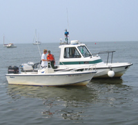 Park ranger boat beside other boat, as ranger conducts a vessel safety check.