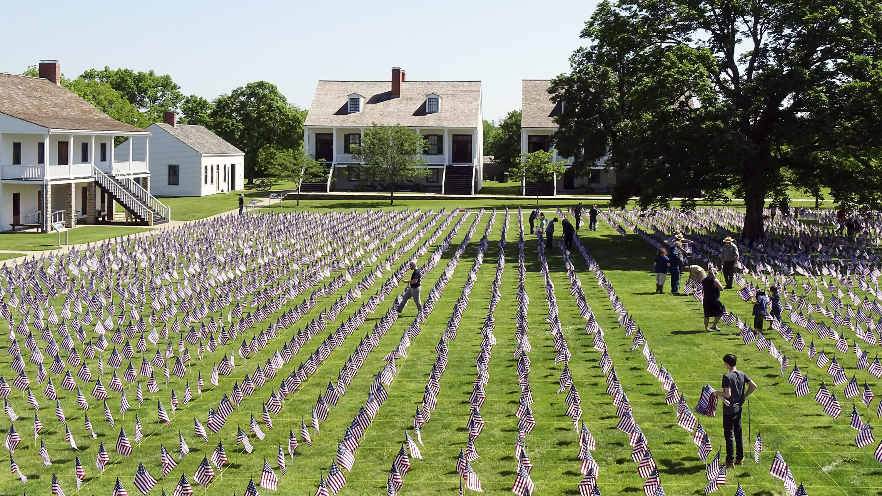 Community members setting up the Field of Honor with 8,500 flags.