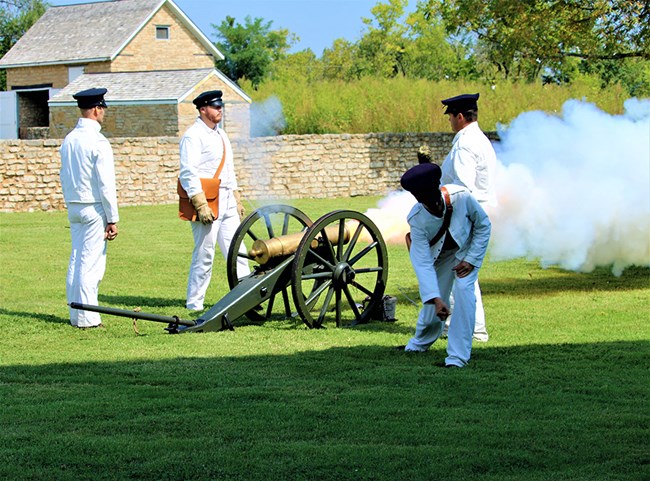 soldiers firing cannon