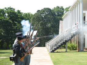 Reenactors firing muskets