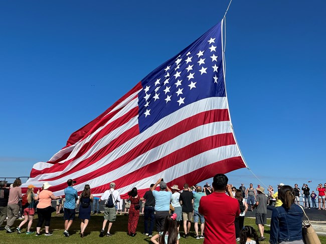 A very large 33 star American flag is raised at Fort Sumter