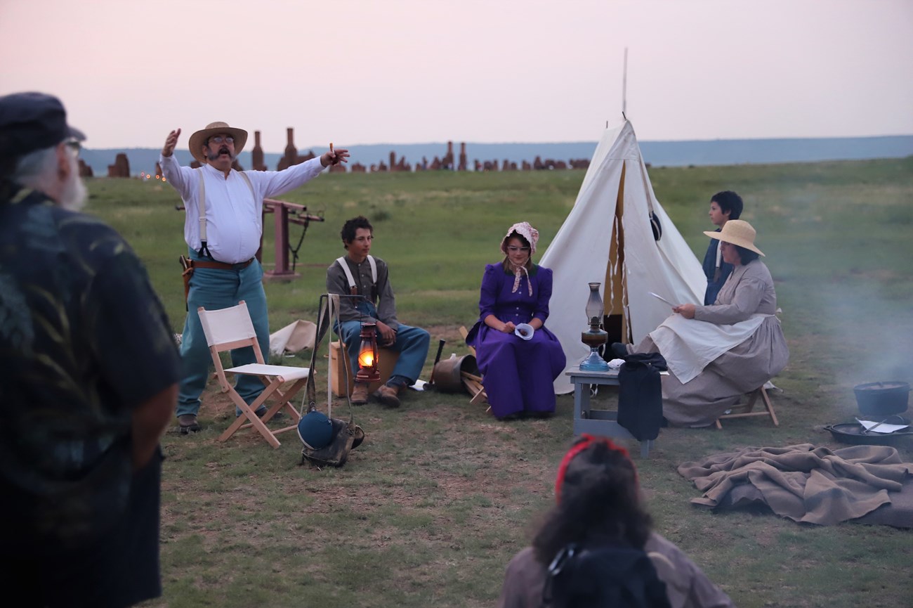Living history volunteers act out a skit during a Candlelight Tour
