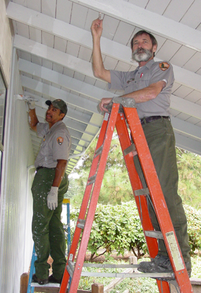 Image of two employees painting the Visitor Center