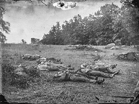 Dead soldiers litter the battlefield.