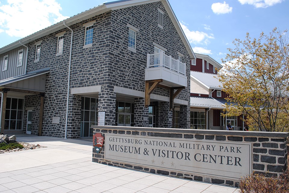 The front of the Museum and Visitor Center and the park sign.