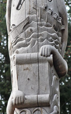 detail of a scroll carved onto a totem pole