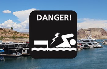 do not swim near docks icon overlaid on photo of houseboats in marina