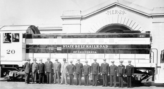 men in uniform in front of diesel train at San Francisco Pier