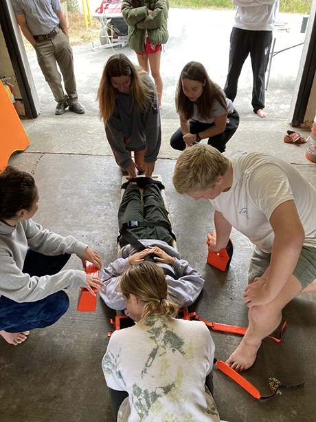 Junior lifeguards practice assessing a patient for injuries