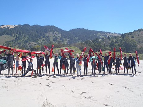 Junior lifeguards display their swim rescue buoys and swim fins at the beach