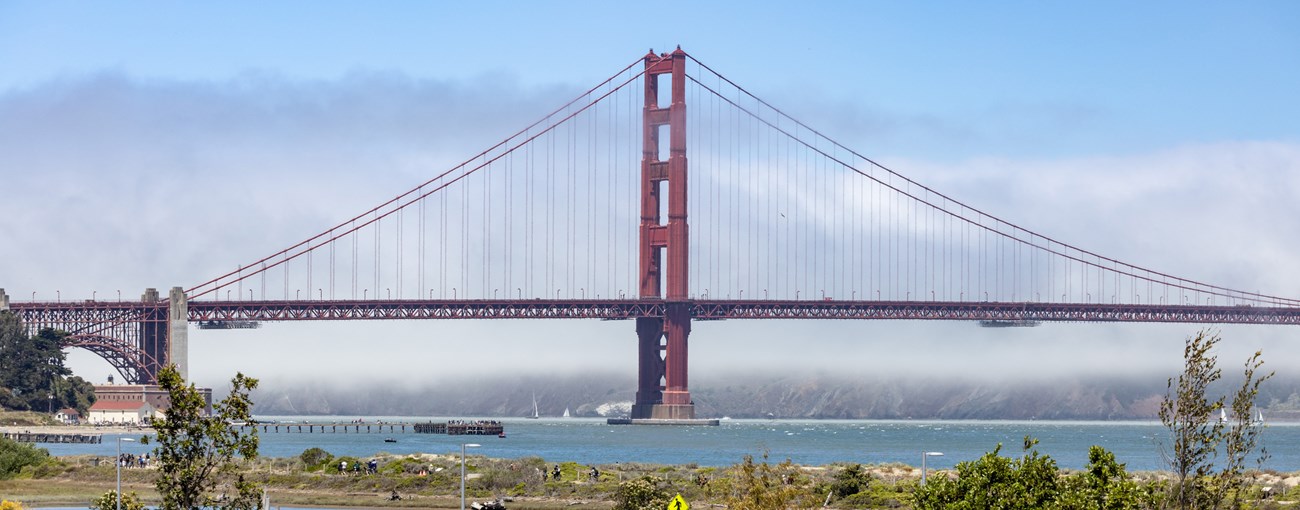Fog rollls into San Fransciso beginning to cover the Golden Gate Bridge