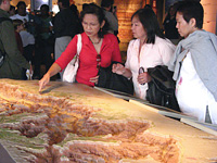 Park visitors examining the relief map at Yavapai Observation Station