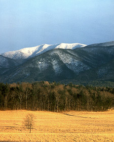 Snowy mountain peaks rise above the valley in Cades Cove.
