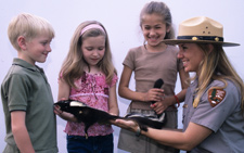 A ranger speaking with children.