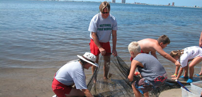 Park rangers help visitors find out what fin or shell fish are in the sound near Naval Live Oaks.