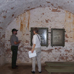 A ranger describes the significance of Fort Barrancas casemate to a park visitor.