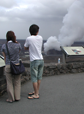 Visitors look at the new vent in Halemaumau from the overlook at Jaggar Museum