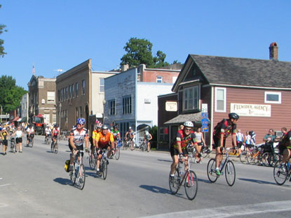 Bicyclists along West Branch's Main Street pause to look at the historic downtown buildings.