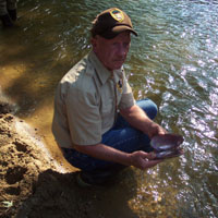 VIP Ralph Keaton collects mussel shells as part of an inventory project.