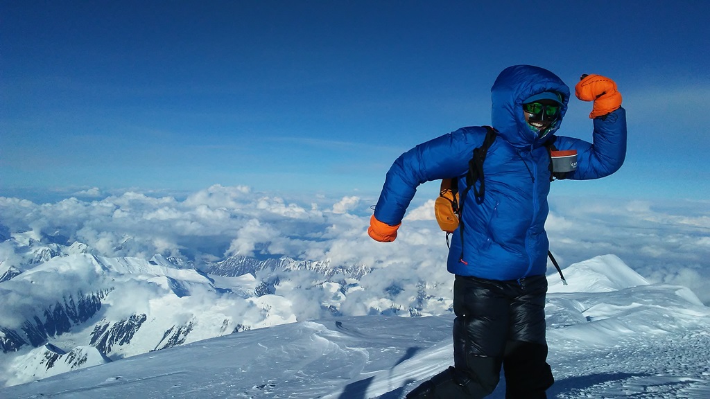 Climber Katie Bono enjoys a cold, but gratifying moment  on the summit after her speed ascent.