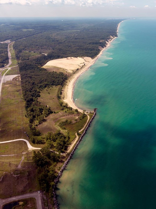 Aerial photograph of a large open sand dune along the coast of Lake Michigan