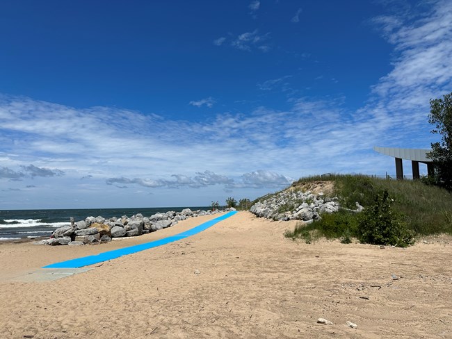Sandy beach area with bright blue pathway