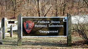 large wooden sign with words Dunewood Campground and the NPS Arrowhead Logo