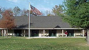building with grass in the front and the American flag flying above the roof building with grass in the front and the American flag flying above the roof