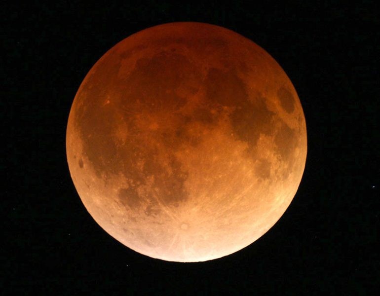The moon is red which is refered to as a Blood Moon
