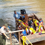 Kids on a traditional Louisiana boat wait for a ranger to cast off.