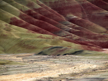 Image of the Painted Hills, zoomed in with sun raking across the foreground.
