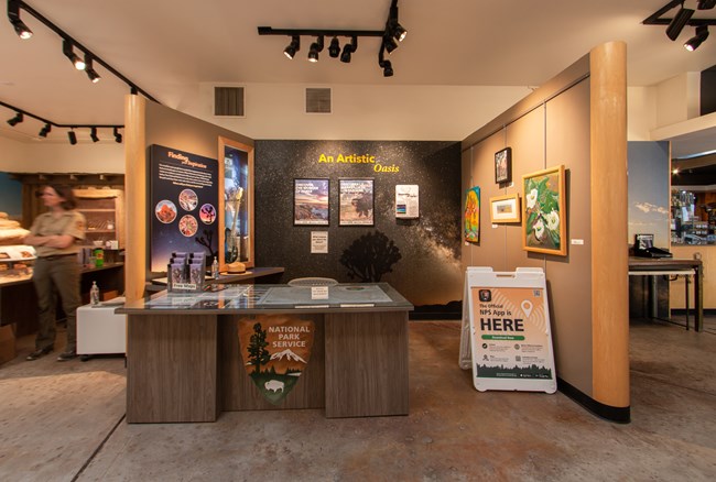 A lowered information desk in the exhibit section of a visitor center