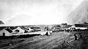Early Kalawao, with line of cliffs in the background.