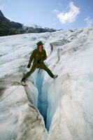 Ranger over glacial crevasse. Ranger over glacial crevasse.