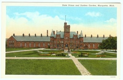 A large building with a sunken garden in the foreground depicted on a postcard.