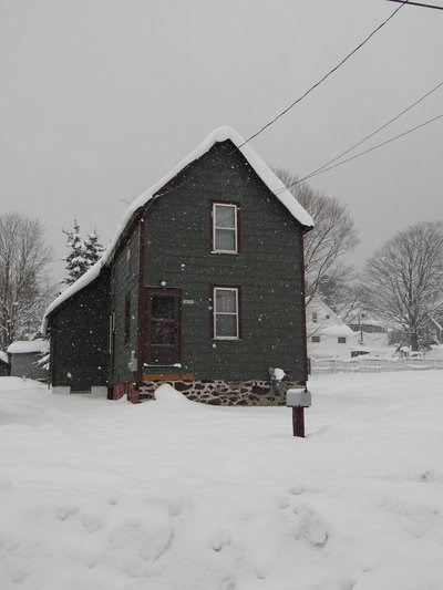 A house with snow falling.