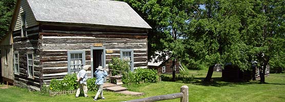 Visitors stroll by a former miner's cabin at old Victoria.