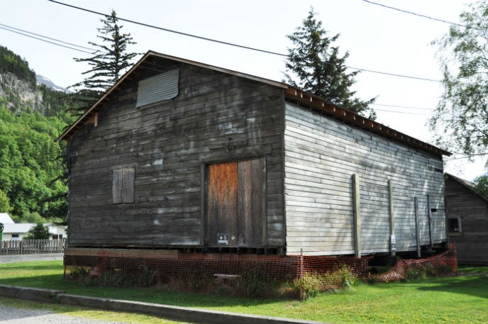 Modern photo of an old wooden building raised above the ground.