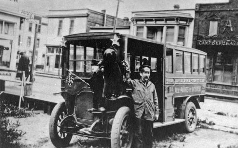 Black and white historic photo of Martin Itjen standing in front of his streetcar.