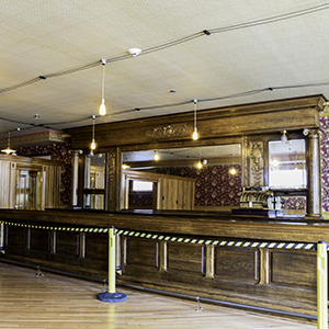 Interior of an empty saloon, with the bar being the main focus